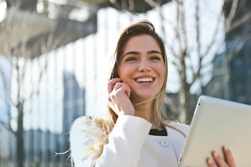 Woman on a phone call with a computer. 