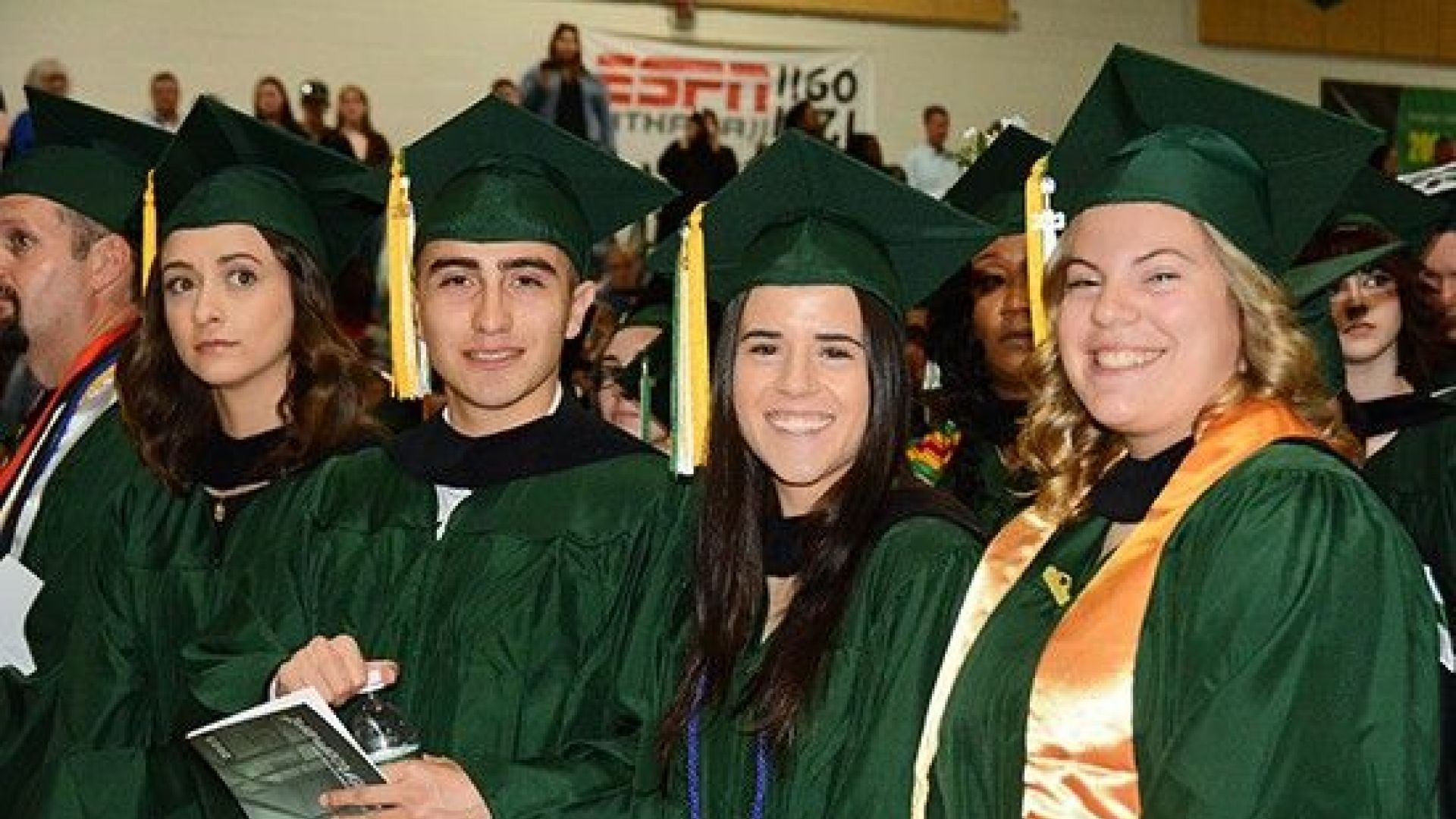 Graduates smiling at commencement