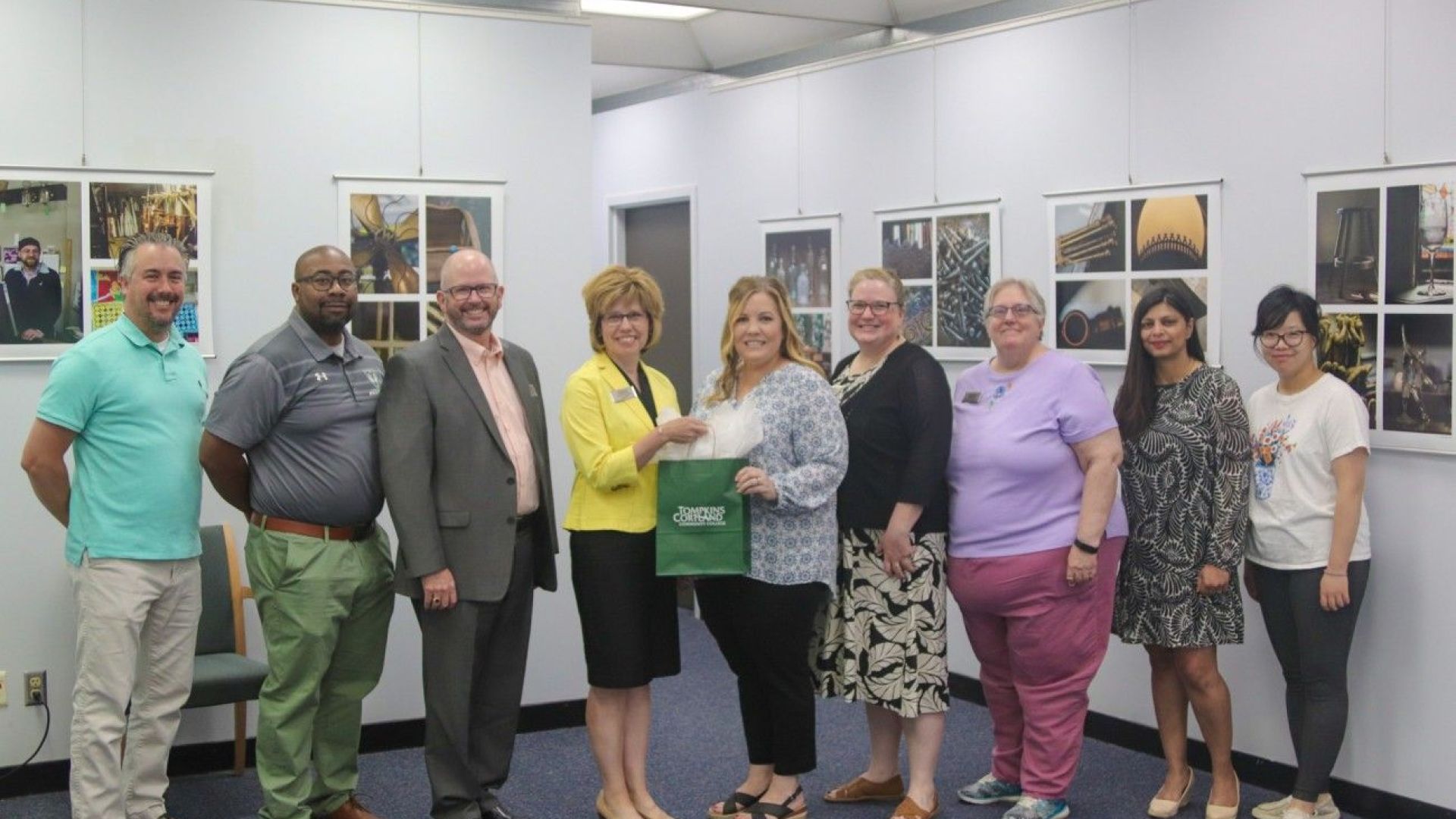 Jennica Petrella-Baum and eight others standing and smiling