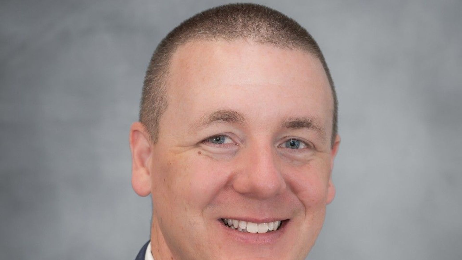 Chris Austen in coat and tie