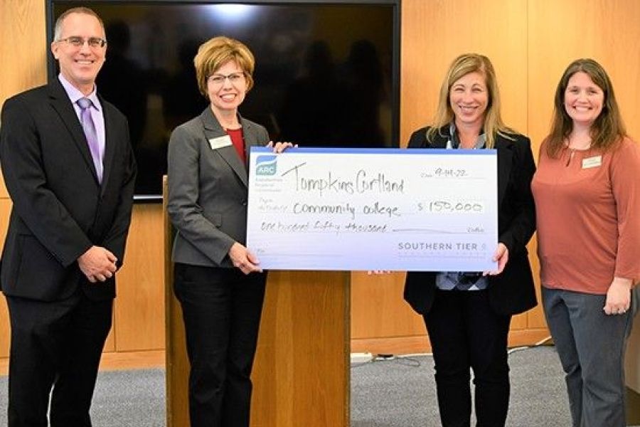 President Kremenek accepts check from ST8 Executive Director Jen Gregory