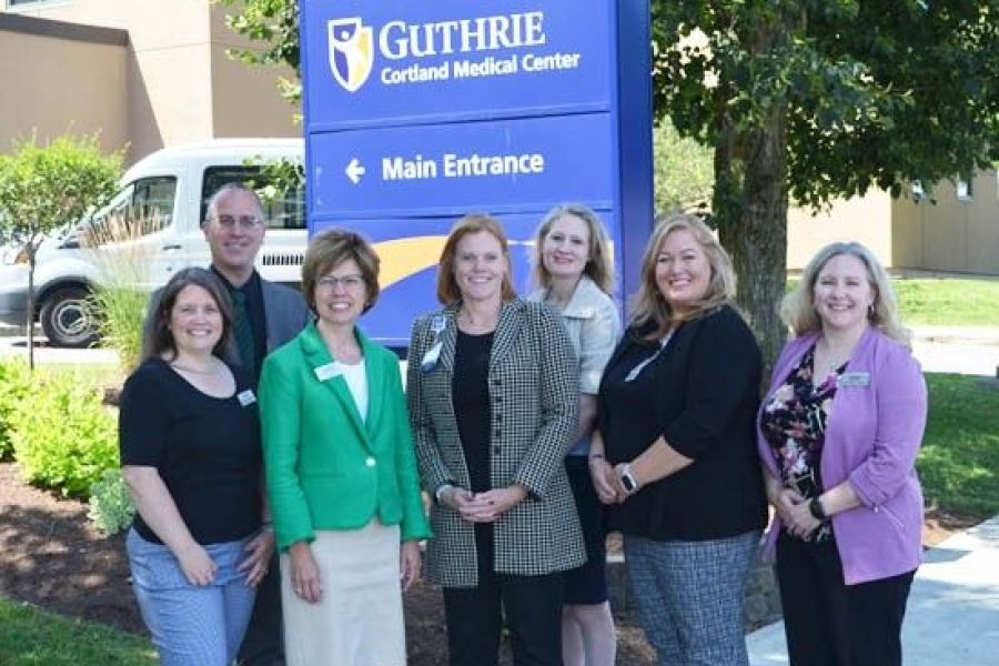 Executives from Guthrie Cortland and TC3 posing at hospital entrance
