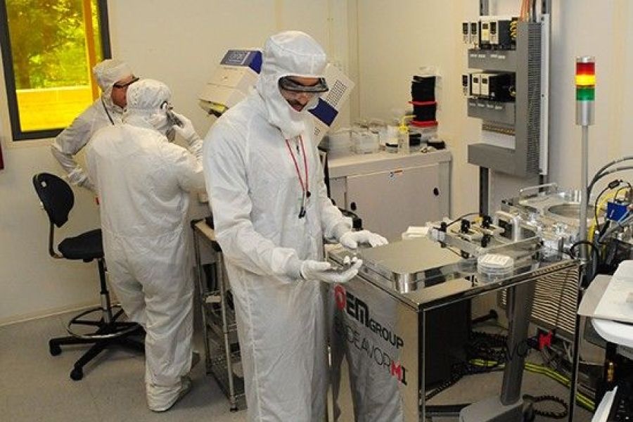 Three workers in cleanroom