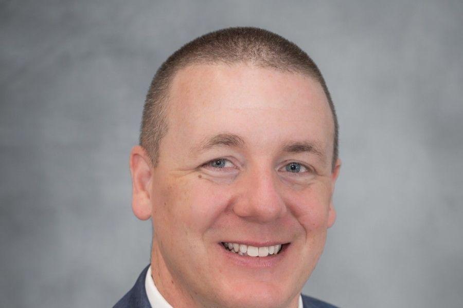 Chris Austen in coat and tie