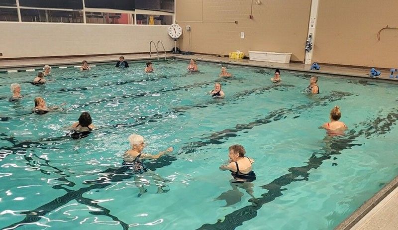 group of swimmers participating in water aerobics