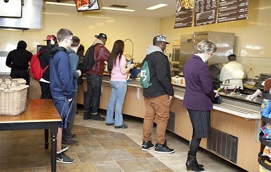 Students standing in line in dining hall