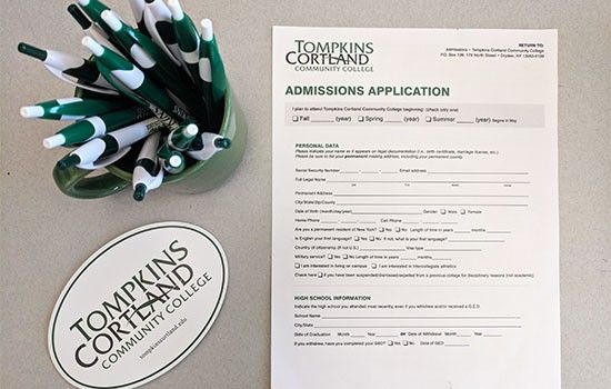 Tompkins Cortland application, pens, and sticker