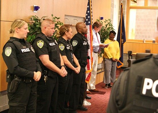 Four campus police officers taking the oath of office