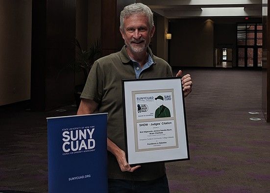 Bob Edgecomb holding SUNYCUAD award